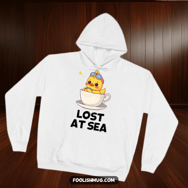 Funny hoodie showcasing a confused rubber ducky character piloting a teacup, appearing lost at sea in a delightful way.
