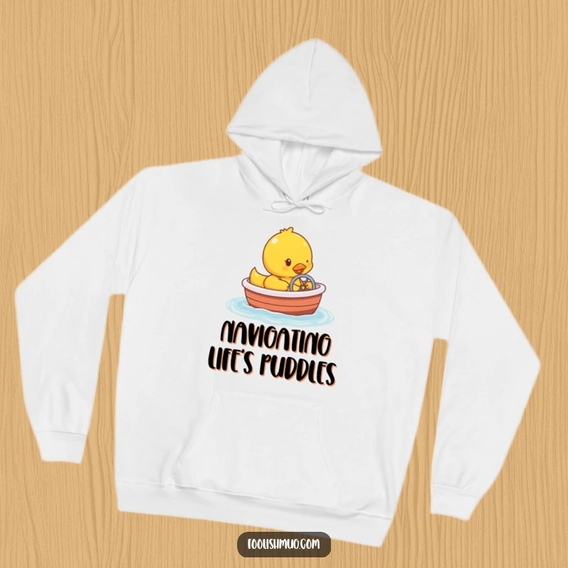 Funny rubber ducky character humorously steering a tiny bathtub boat, depicted on a cozy hoodie for warmth.