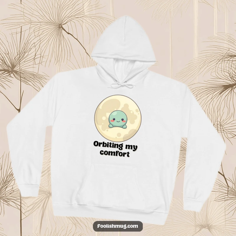Funny Hoodie: A shy planet character seeks comfort behind a large, smiling moon, radiating warmth and gentle humor.
