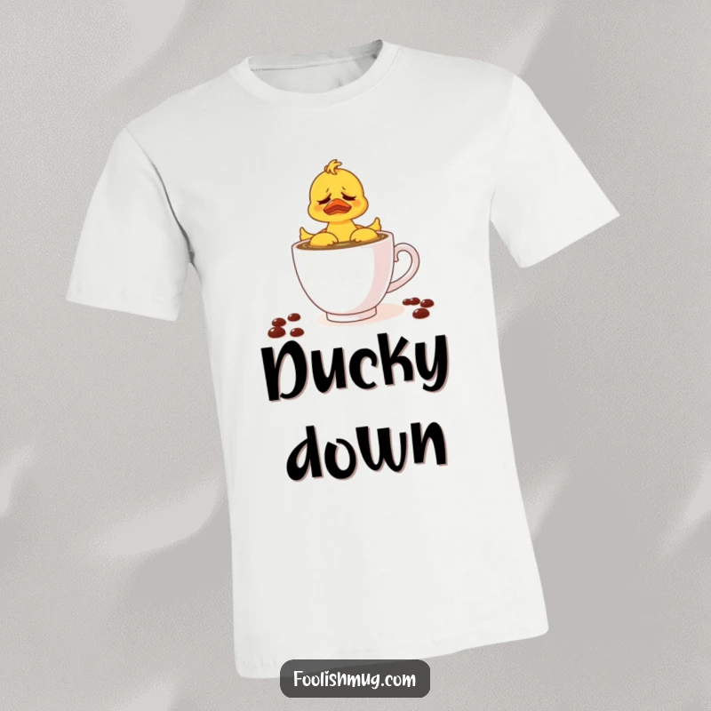 Funny t-shirt with a frustrated rubber ducky attempting to swim in a teacup of coffee, perfect for relatable morning humor.
