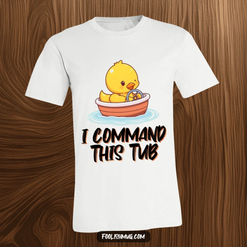 Funny rubber ducky character trying to steer a miniature bathtub boat across wavy water, on a t-shirt.