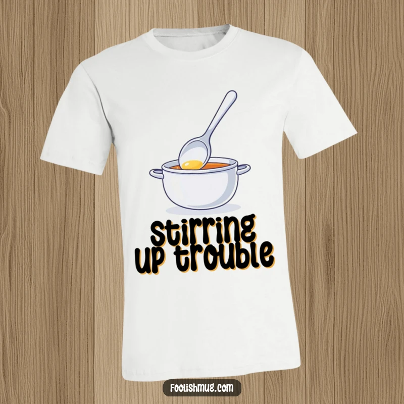 Funny t-shirt showing a bright spoon character comically stirring invisible soup, perfect for kitchen antics and humorous everyday wear.